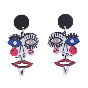 Detail of artistic acrylic earrings featuring abstract Picasso-style colorful face patterns