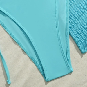Macro detail of sky blue bikini bottoms showing precision stitching and elastic fabric