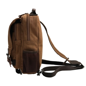 Brown canvas crossbody bag with multiple zipper compartments and side mesh pocket