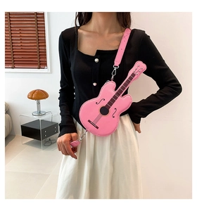 Pink guitar-shaped crossbody bag in PU leather featuring realistic printed string details