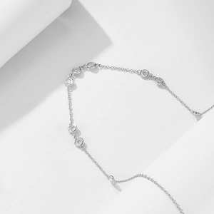 Macro detail of 925 sterling silver chain featuring round sparkling zircon stones