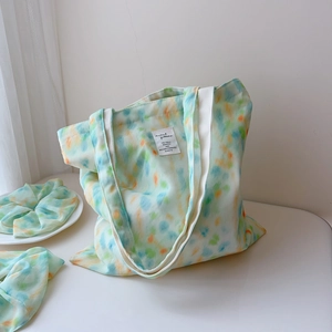 Detailed view of mint green watercolor cotton tote bag with matching hair scrunchie set
