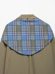 Detail view of the vintage plaid patchwork on the back of the olive green jacket