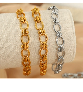 Detailed shot of three gold and silver titanium steel bracelets on a jewelry display
