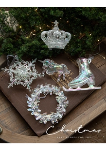 Detailed view of iridescent Christmas ornaments set including snowflake and crown shapes