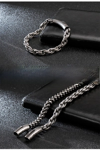 Macro view of vintage style braided stainless steel chain bracelet with cylinder clasp