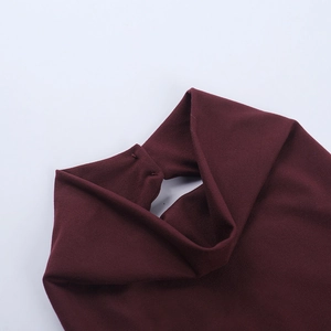 Close-up of the back neck opening and button detail on a wine red halter top