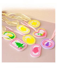 DIY Christmas resin pendant variety featuring snowflake and tree shapes with silk ribbons