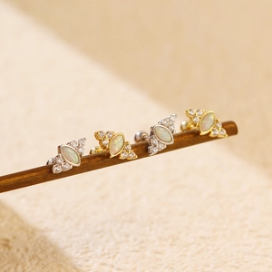 Close-up of opal marquise earrings with micro-pave diamonds and secure screw-back design