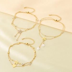 Three gold double-layer stainless steel anklets with clover, heart and pearl charms