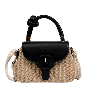 Fashionable straw handbag with black leather accents and woven crossbody strap