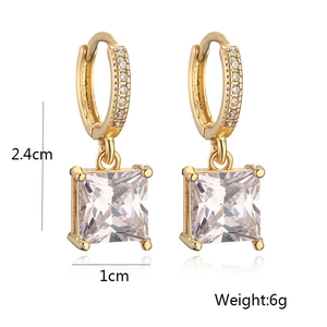 Detail shot of gold earrings with square zircon pendant and dimensions 2.4cm by 1cm