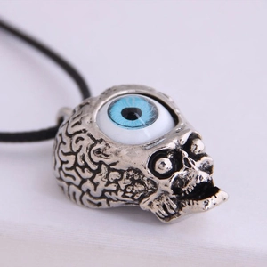 Retro gothic skull pendant with striking blue evil eye on a black rope necklace