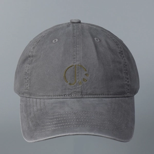 Close-up of olive green embroidered logo on a dark grey washed cotton baseball cap