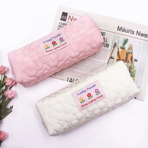 Quilted floral pencil cases in pink and cream colors with Lucky Flower label