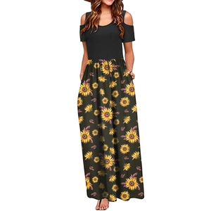 Close-up of cold shoulder design and sunflower print on a black summer maxi dress