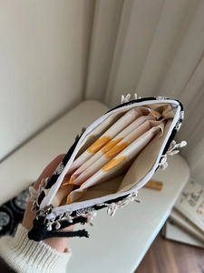 Detailed interior of lace canvas pouch holding four 240mm feminine hygiene pads