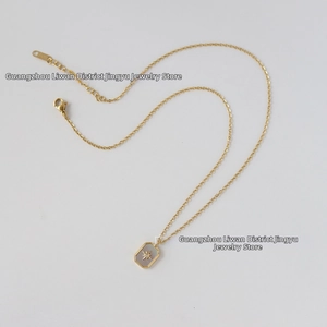 Detail of 18K gold plated necklace with white shell rectangle pendant and starburst