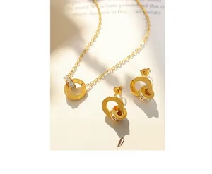 Macro view of 18K gold plated necklace and earrings set with Roman numerals and zircon