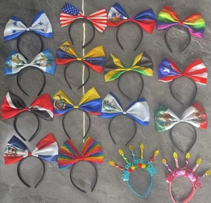 Flat lay of multiple flag pattern bow headbands including USA and Mexico designs