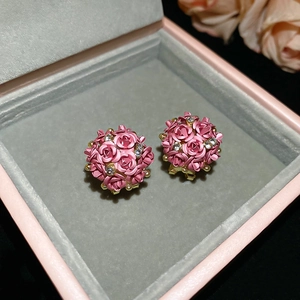Close-up of pink rose sphere earrings with sparkling crystals in a jewelry gift box