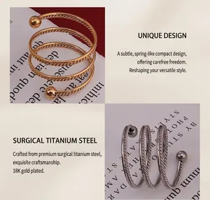 Detail of 18K gold and silver plated titanium steel spiral ring with twisted rope texture