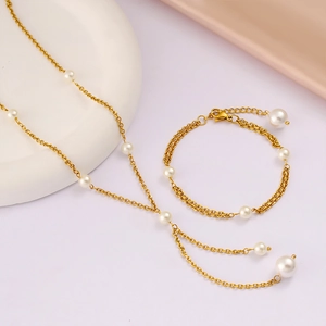 Elegant gold pearl necklace and bracelet set displayed on silk for French style fashion