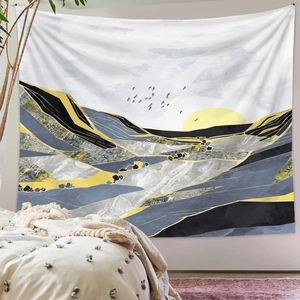 Detailed view of an artistic mountain tapestry in grey and yellow above a bedroom bed