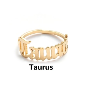 Detailed view of golden Taurus zodiac letter ring with adjustable open band design
