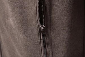 Macro shot of dark brown suede fabric texture and high-quality metal zipper details