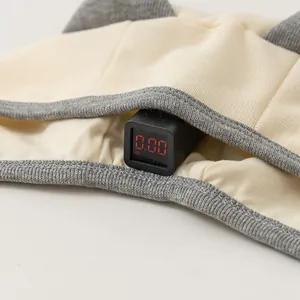 Detail view of newborn hat fabric tested for zero fluorescence with a digital meter