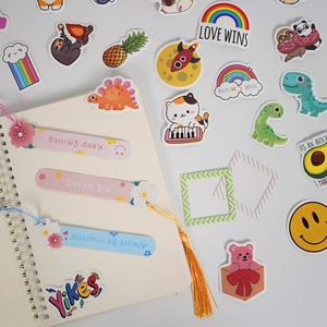 Detailed flat lay of DIY journal set with stickers, bookmarks, and spiral notebook