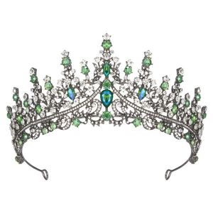 Detailed close-up of green crystal crown with emerald teardrop stones on dark metal