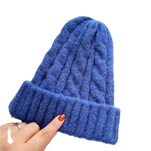 Blue thick cable knit beanie hat for winter warmth with a soft textured aesthetic