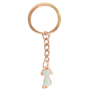 Detail of rose gold metal keychain featuring a light green enamel cat charm and lobster clasp