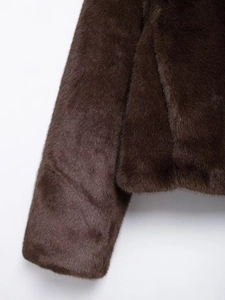 Detailed close-up showing the soft texture and sheen of dark brown faux fur coat sleeves