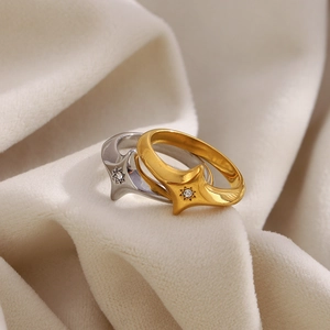 18K gold plated stainless steel star rings with central crystal on textured background