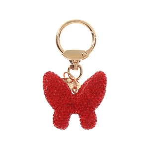 Sparkling red rhinestone butterfly keychain with gold plating on a white background