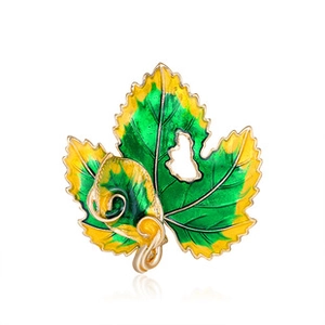 Detailed close-up of leaf brooch with green enamel gradient and gold镂空 hollow design