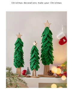 Three green felt Christmas tree desk ornaments with wooden star and base in cozy scene