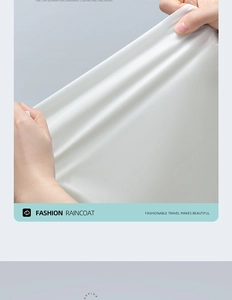 Detailed close-up showing the high-elasticity and smooth texture of the beige raincoat fabric