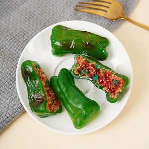 Realistic PVC green pepper meat keychain set on a white plate with golden fork accessory