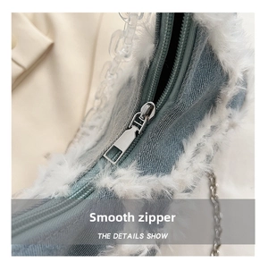 Detailed close-up of light blue denim bag featuring white faux fur trim and silver zipper