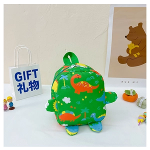 Detail of green kids backpack featuring colorful cartoon dinosaur prints and side wings