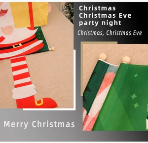 Detail of Christmas banner featuring Santa Claus pattern with wooden rod and red hanging rope