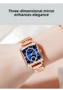 Detail of rose gold rectangular watch with blue dial and multifaceted glass on wrist