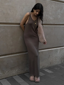 Detail of slim fit dark brown knitted V-neck maxi dress with soft texture and chic accessories
