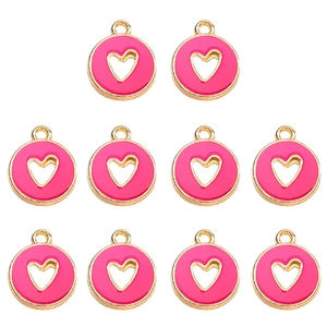 Macro detail of ten rose pink enamel heart charms with gold plated alloy edges