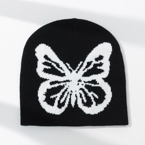 Winter knitted black beanie hat featuring a large white butterfly jacquard pattern