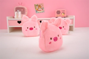 Detail view of cute pink plush pig coin purses with embroidery and metal zippers